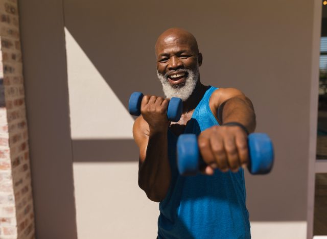 happy senior man exercising with dumbbells to look and feel younger