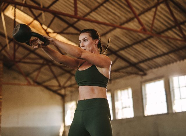 woman demonstrating kettlebell swing to get a bigger butt