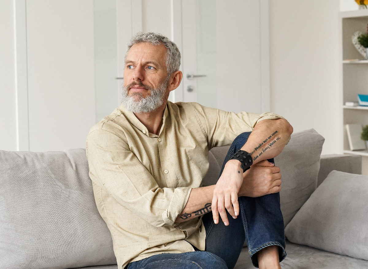 man sitting on couch, demonstrating effects of being 60 and sedentary