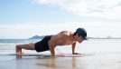 fit man performing beach pushups, demonstrating how to start to lose belly fat in seven days