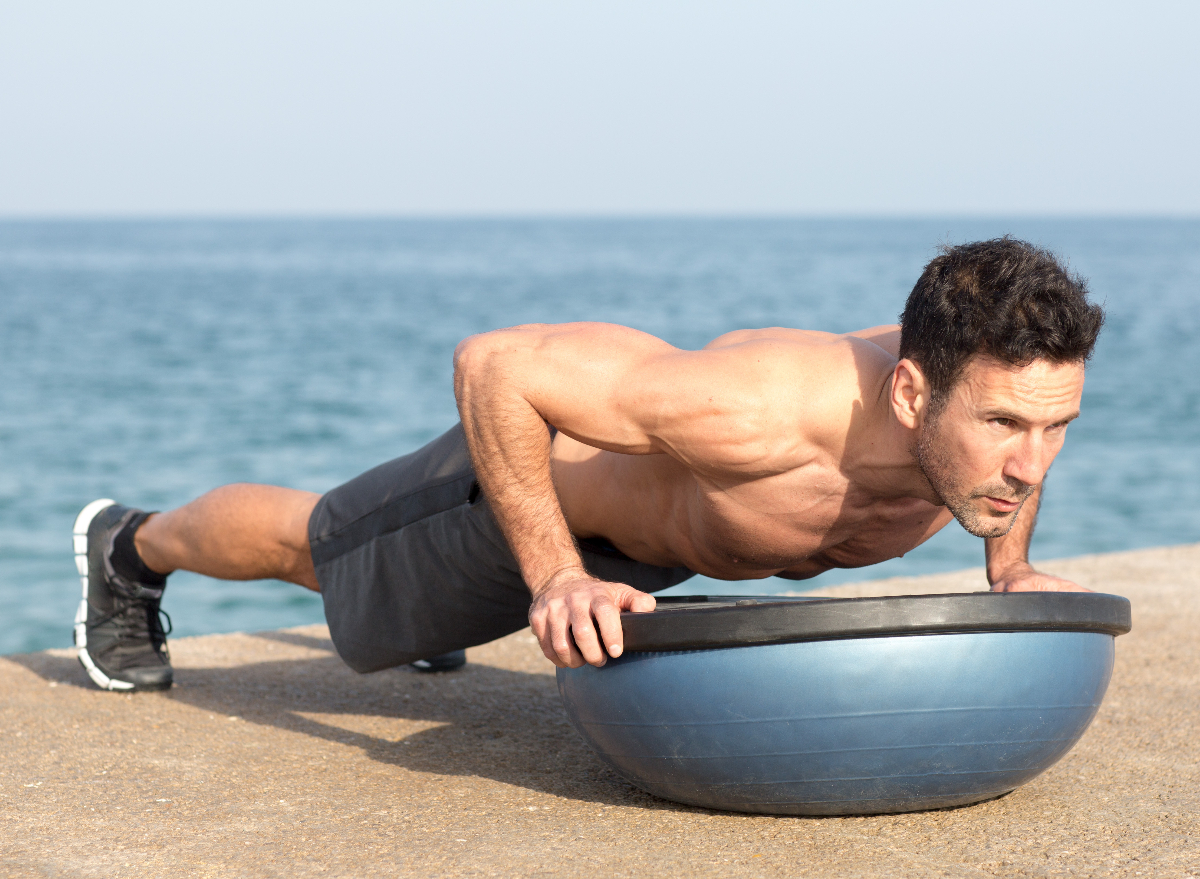 fit man performing bosu ball pushup to start to lose weight in a week