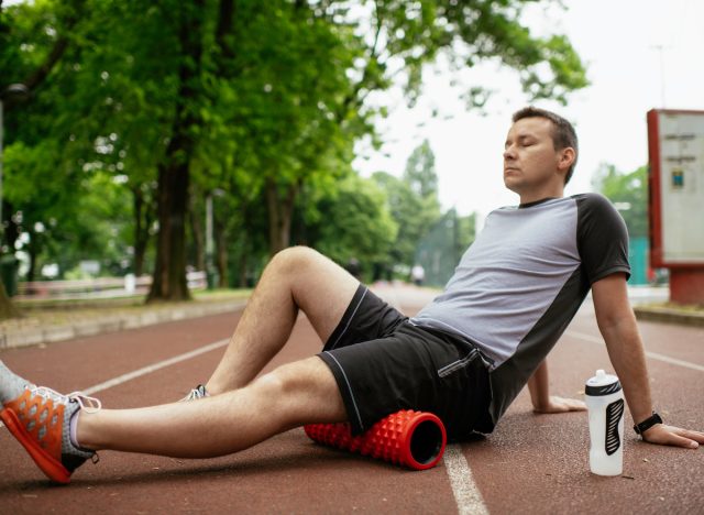 man relaxed doing foam rolling exercises for lower back pain