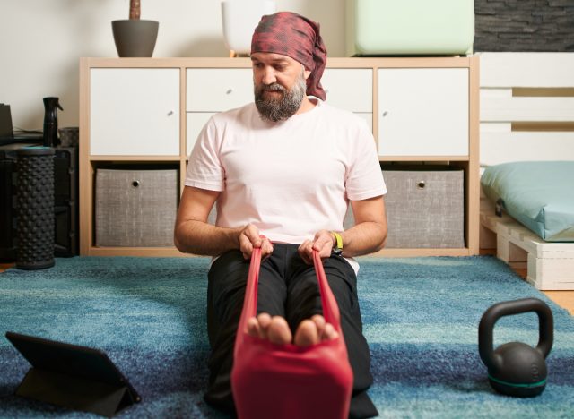 Man demonstrating seated exercises with resistance bands to look good in formal wear