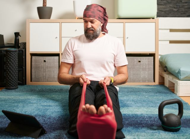 man demonstrating resistance band seated exercises to look good in formal attire