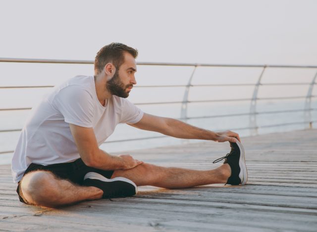man stretching before workout, workout myths