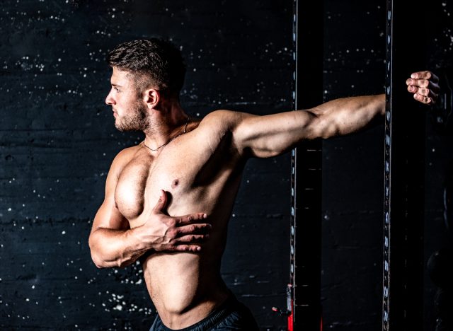 man stretching chest muscles doing exercises to look good in a suit