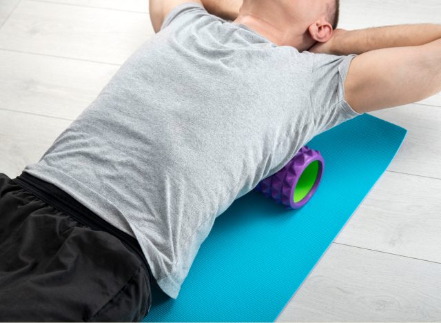 man doing foam rolling exercises for lower back pain