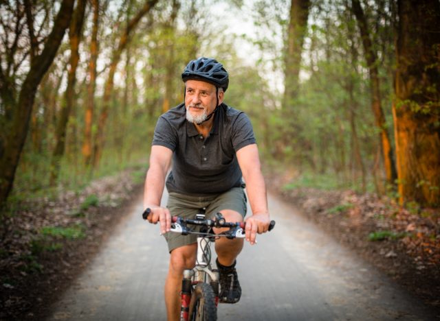 A mature man riding a mountain bike, exercising to slow down aging