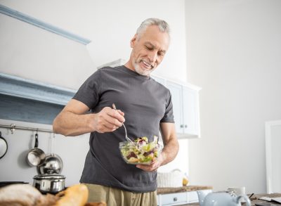 mature older man eating salad