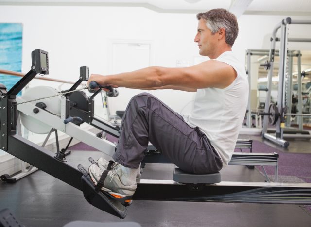 Mature man working on a rowing machine