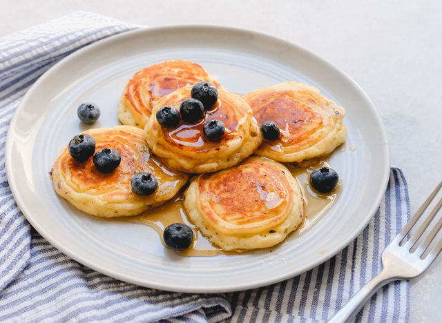 perfect mini blueberry pancakes on a plate with syrup