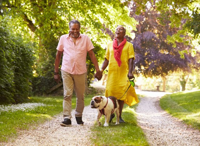 mature couple walking dog