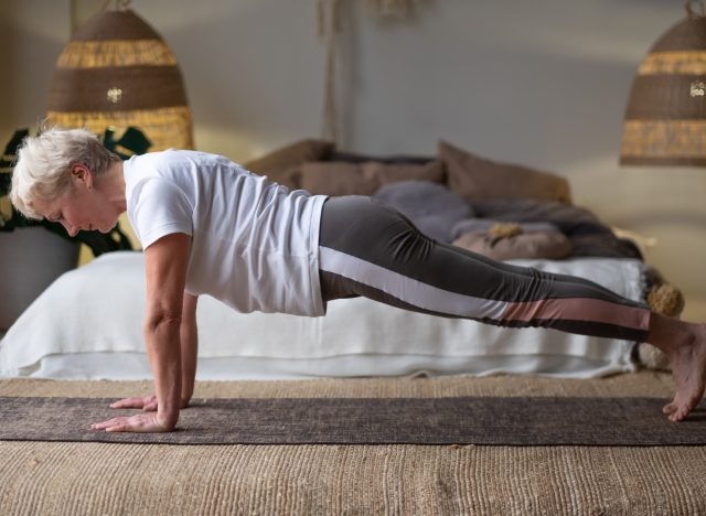 senior woman performing yoga plank