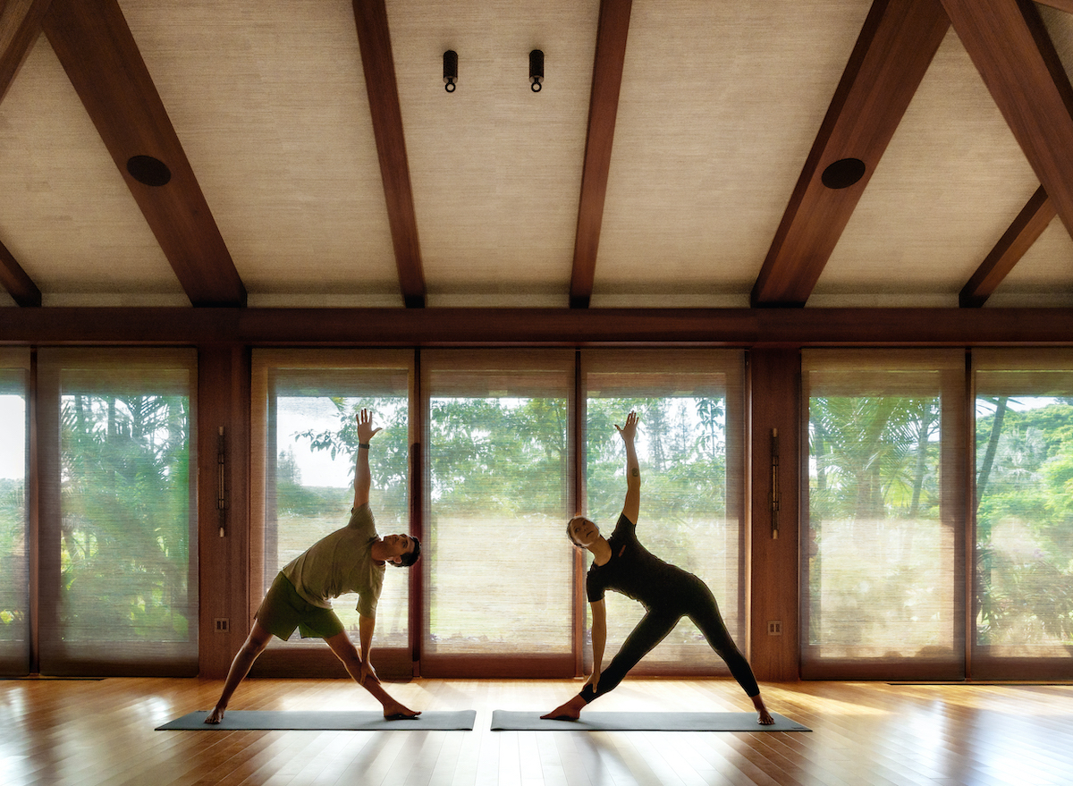 two fit individuals doing yoga session at Sensei Lanai
