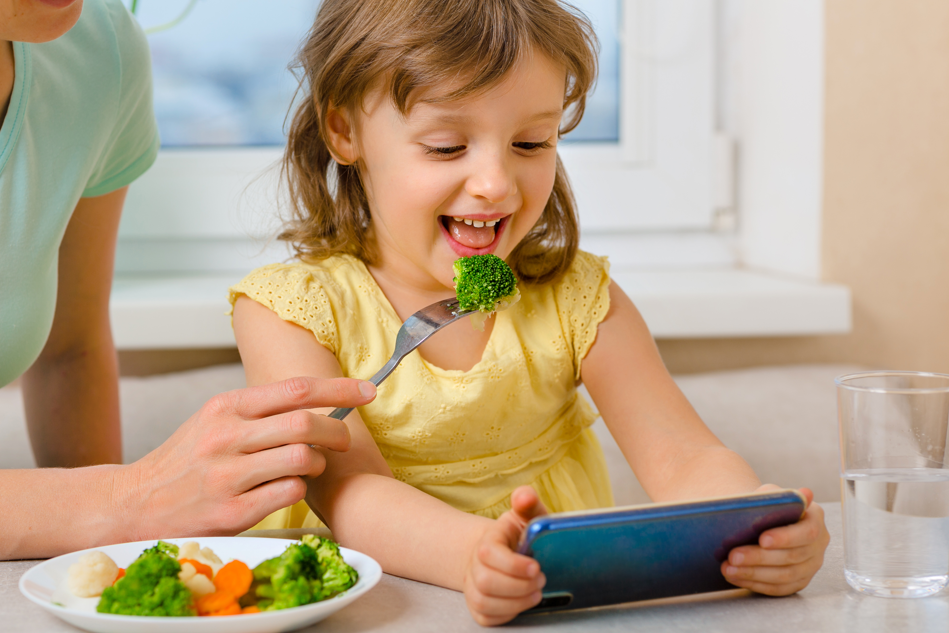 Happy Child Eats Broccoli