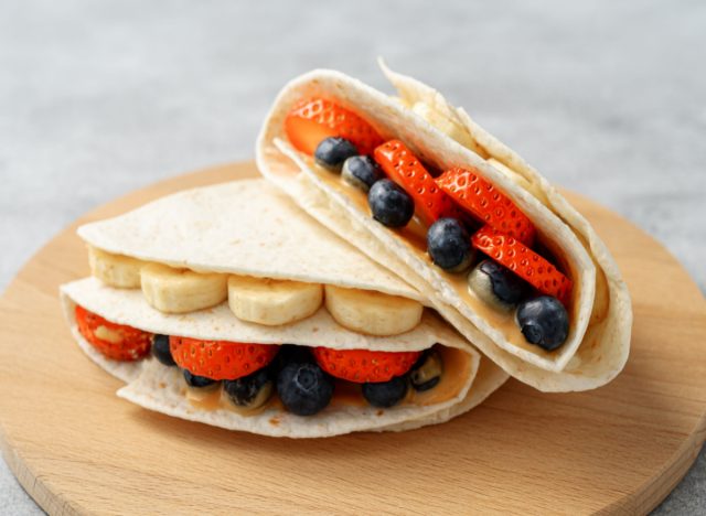 Tortillas filled with peanut butter, bananas, strawberries and blueberries