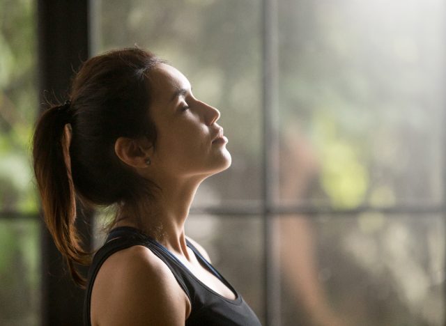 woman breathing, relaxing in peaceful environment