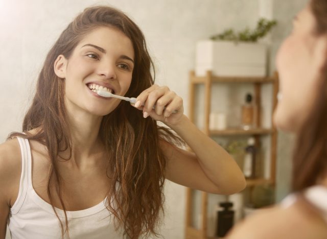 woman brushing teeth nighttime routine