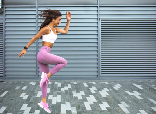 woman doing high knees cardio workout for a tiny waist