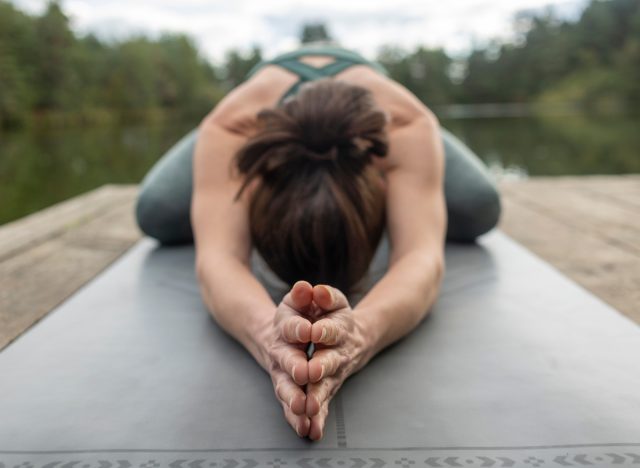 woman performing child's pose to lead an incredibly fit lifestyle