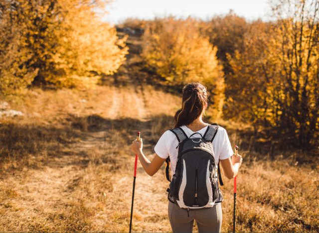 woman hiking downhill in the fall