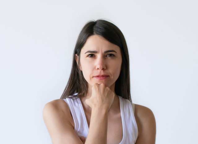 woman performing easy face jowl exercises