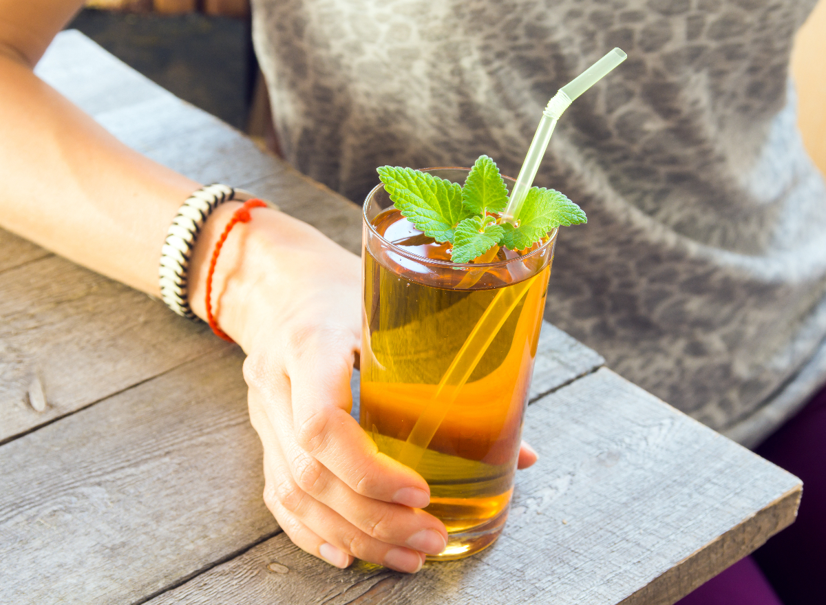 woman holding kombucha tea