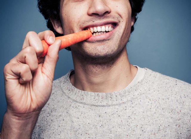 Man eating carrot