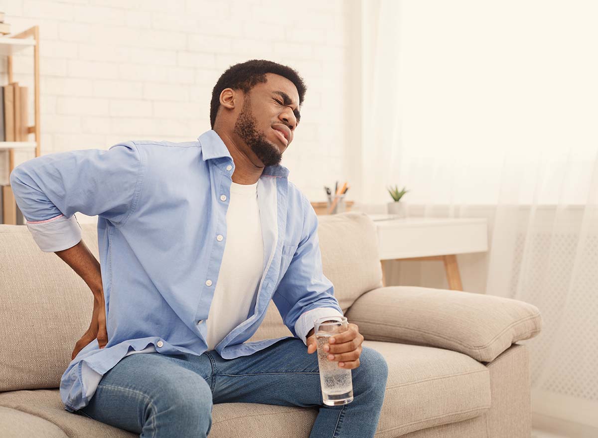 Man with kidney stones holding glass