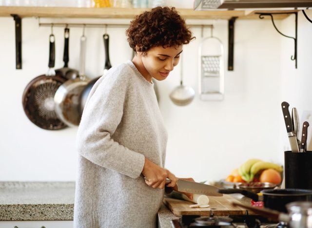 woman cooking at home in bright kitchen