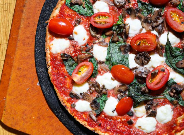blaze pizza with cauliflower crust, tomatoes, and spinach