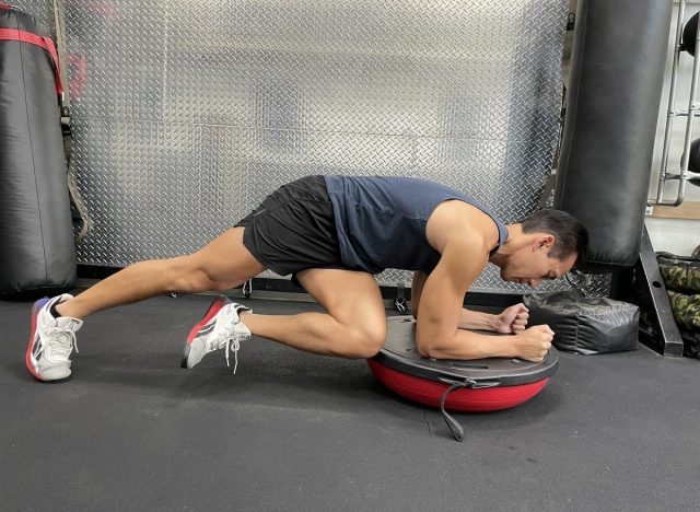 Bosu ball knee to elbow plank