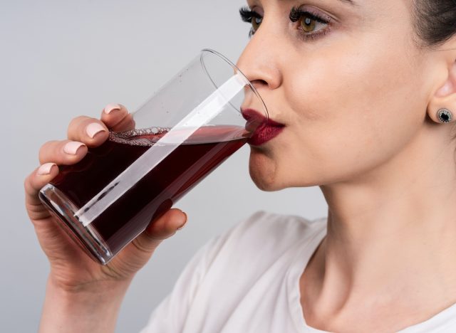 Woman drinking tart cherry juice to sleep better