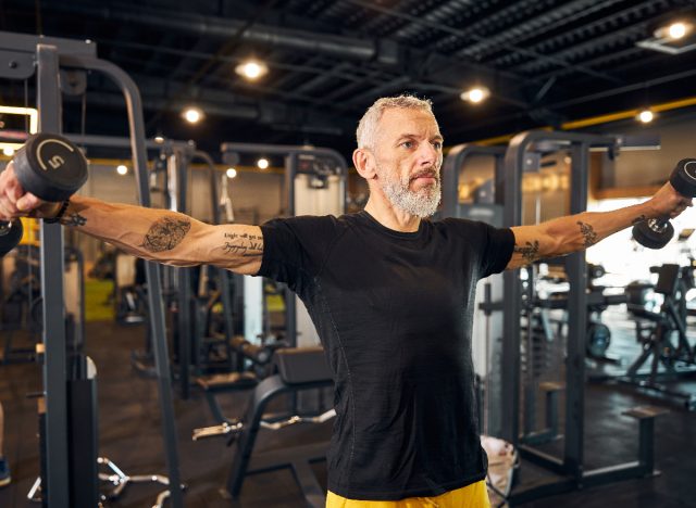 mature man performing dumbbell lateral raise
