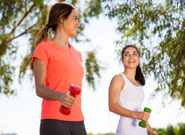 two female friends walking every day with weights outside