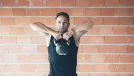 fitness man demonstrating kettlebell exercises to shrink your belly overhang for good