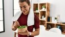 fitness woman eating salad, demonstrating eating after meals