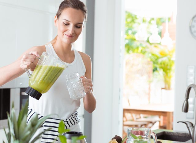 fitness woman pouring a green smoothie, concept of breakfasts for rapid weight loss
