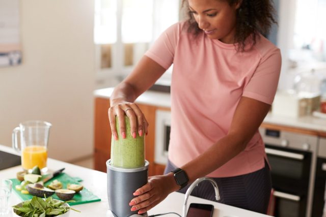 fitness woman preparing protein shake post-workout