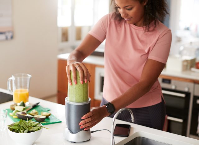 fitness woman preparing protein shake post-workout