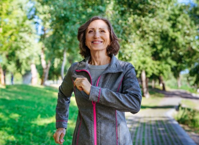 happy mature woman walking outdoors, fitness habits that slow down aging