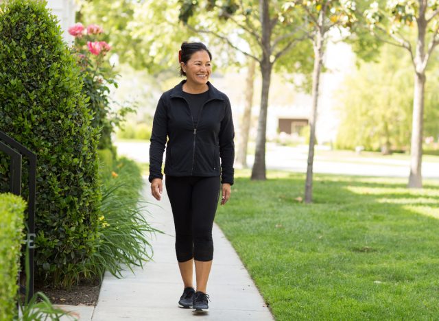 happy middle-aged woman walking outdoors