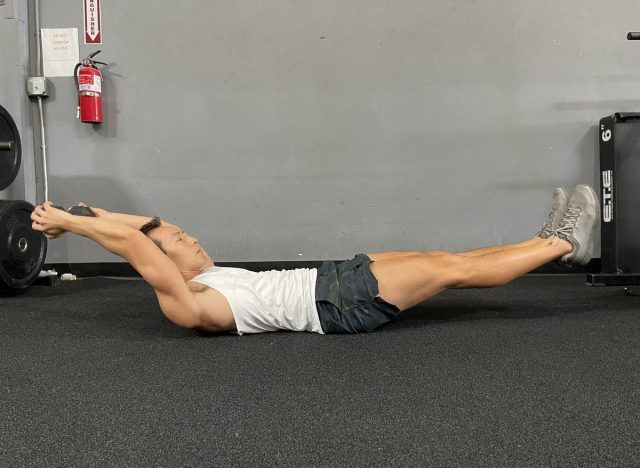 hollow body hold with dumbbell reach exercises for a slimmer stomach