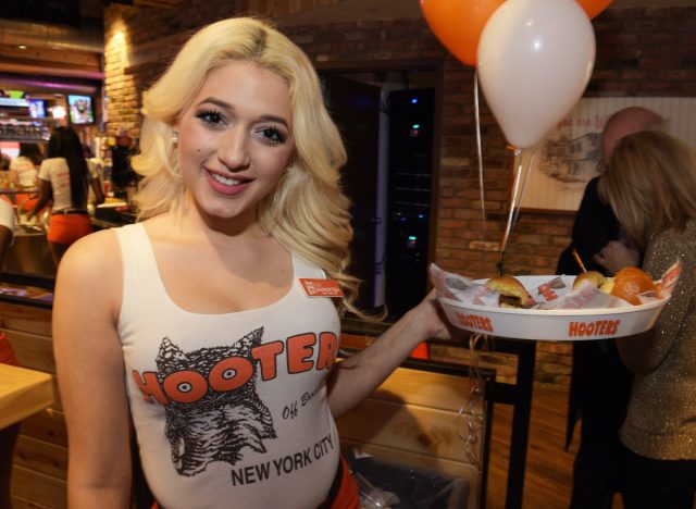 hooters server holding food