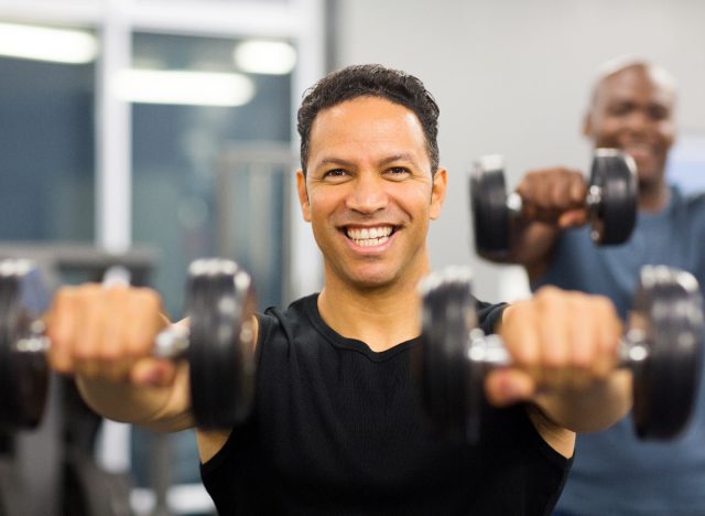 man performing resistance training with dumbbells