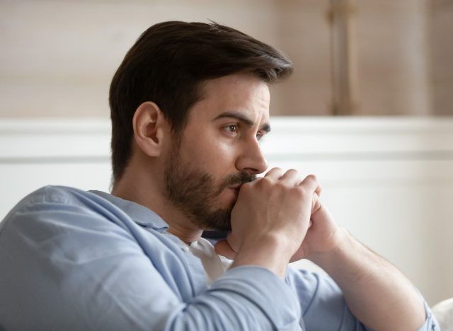 man feeling insecure on couch