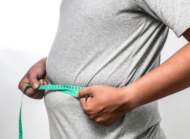 man measuring his visceral fat