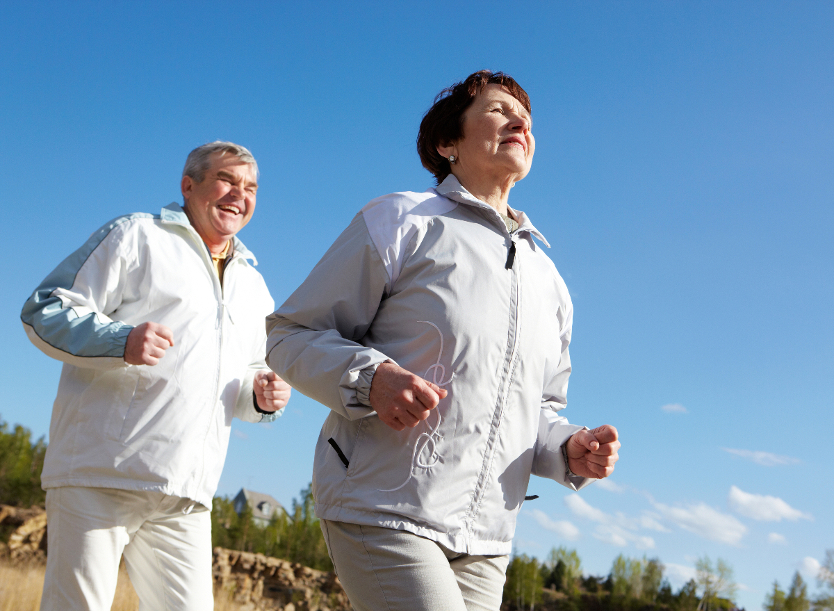 mature couple running outdoors, demonstrating running habits that slow aging