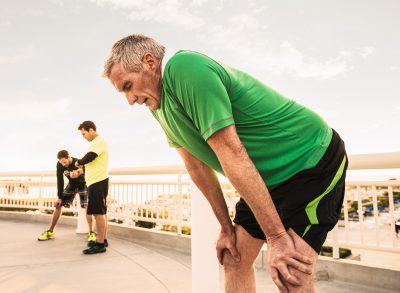 mature man exhausted post-run, demonstrating the mistakes that sabotage weight loss