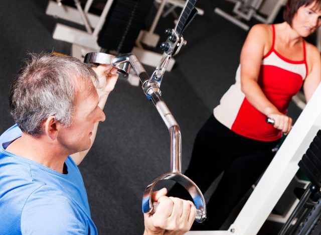 mature man performing lat pulldown